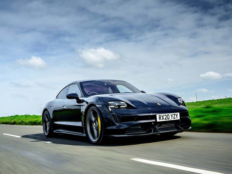 black porsche taycan driving on the road