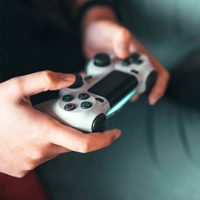 Person holding gray game controller