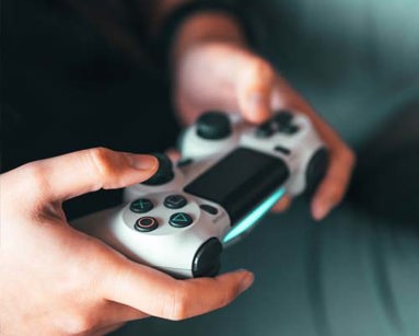 Person holding gray game controller