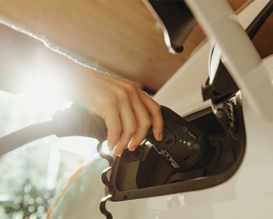 a person charging an electric car