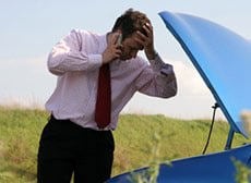 man looking at car engine