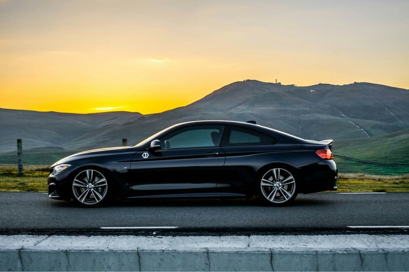 BMW car parked on a mountain road