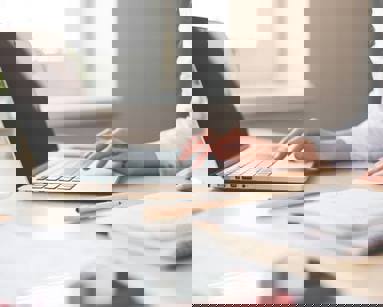 woman typing on laptop