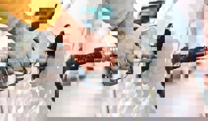 a man pumping fuel into his car at a fuel station