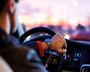 close up of man behind the wheel of a car