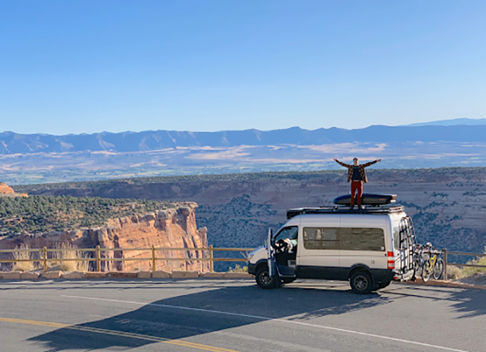 man standing on top of van