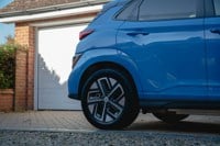 Blue car parked in front of garage door