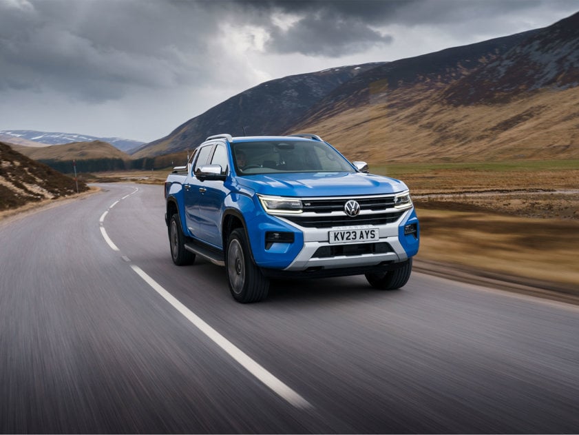 Volkswagen Amarok in blue driving on a country road