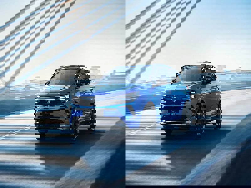 blue vauxhall grandland driving on road