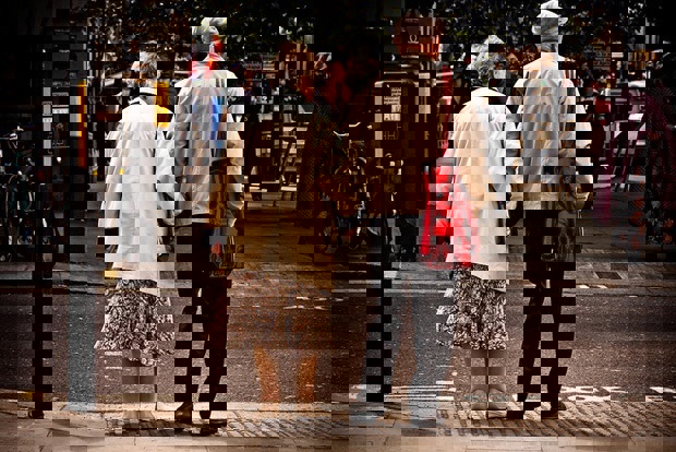 Old people waiting to cross the road