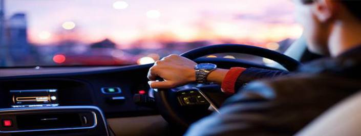 close up of man behind the wheel of a car