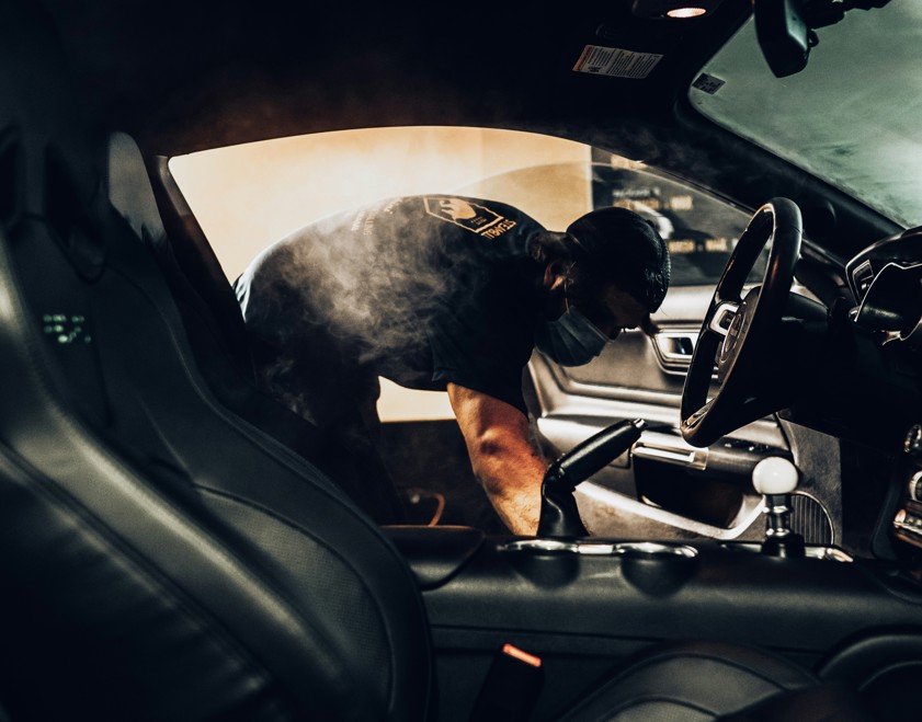 man in black t-shirt driving car