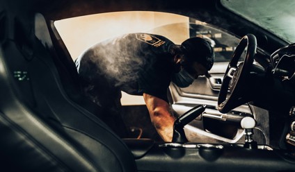 man in black t-shirt driving car