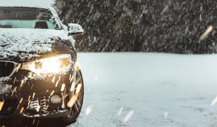 black car on snow covered road during daytime