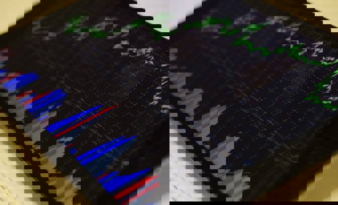 Close up of a tablet device showing stocks and shares graph.
