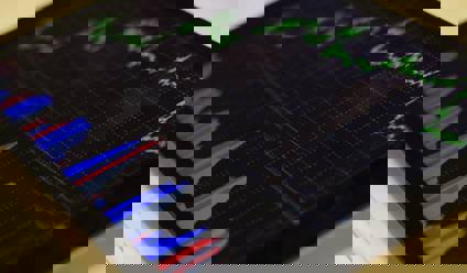 Close up of a tablet device showing stocks and shares graph. 