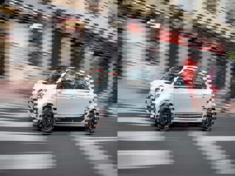Smart Forfour driving along a blurred city street