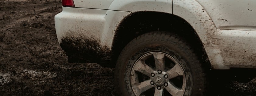 white suv on dirt road during daytime
