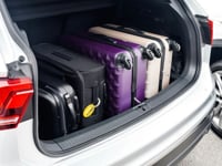 a silver suv with a boot full of suitcases