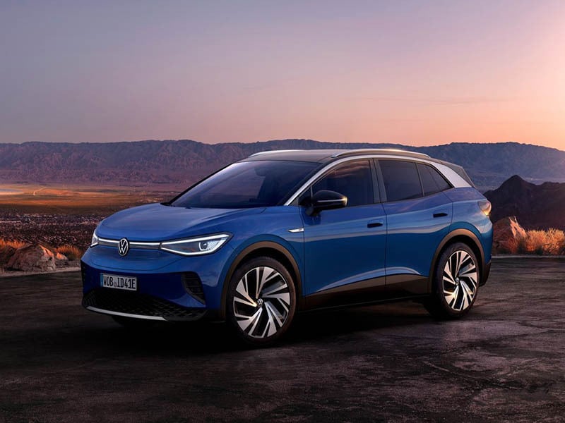 blue volkswagen id4 with mountains in the background