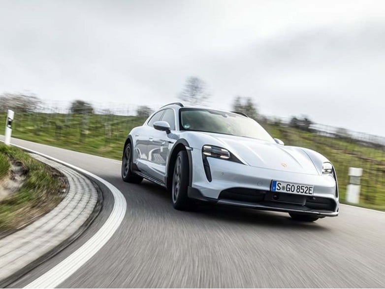 white porsche driving on road