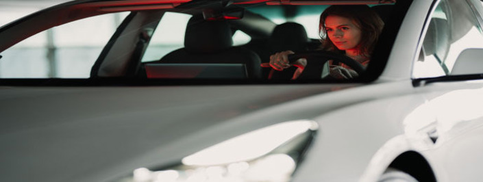 woman driving gray car