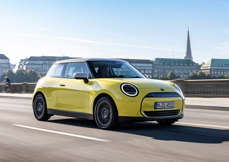 Yellow Mini Cooper Electric driving on the road