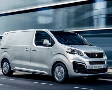 silver peugeot expert driving on road