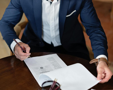 Man in a suit signing documents