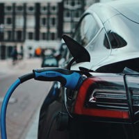 electric car with its charging cable connected