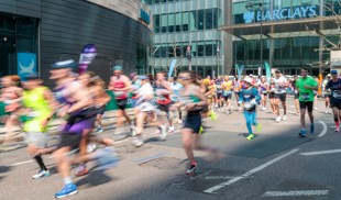 runners participate in a marathon on a city street