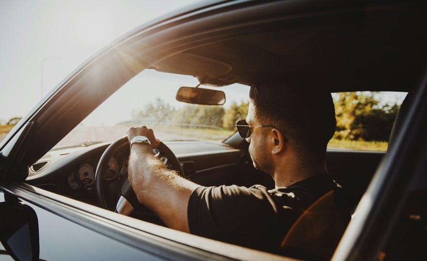 man in black jacket driving car during daytime