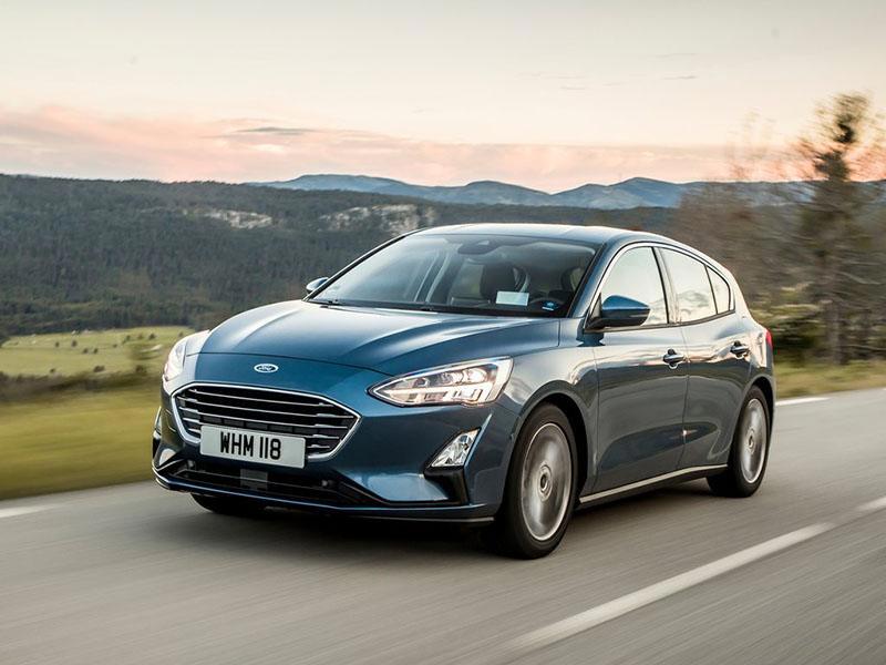 blue ford focus driving on road