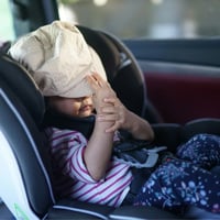 child sitting in a car seat