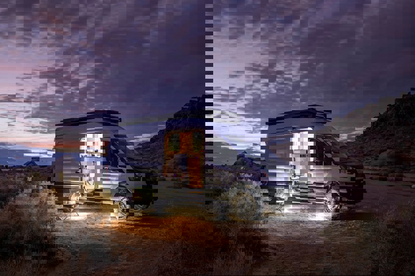 Converted van parked in desert at night