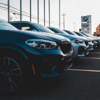 row of bmw cars in dealership forecourt