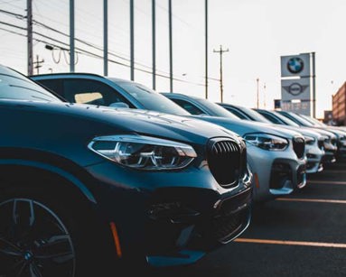 row of bmw cars in dealership forecourt