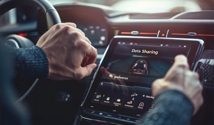 Close-up of a man using a car’s touchscreen infotainment system with data sharing settings visible